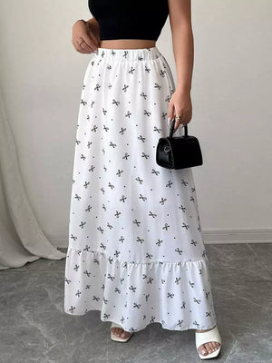 White maxi skirt with black bowknot print and ruffled hem.