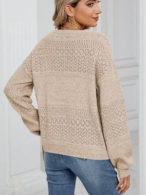 Tan eyelet stitch v-neck pullover sweater with long sleeves.
