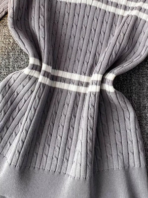 Grey cable knit t-shirt with white stripes and a polo collar.