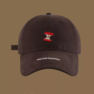 Brown baseball cap with apple core embroidery and "YOUTH DAYOFF" text.