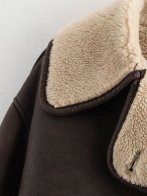 Chocolate aviator jacket with plush shearling trim and collar detail.