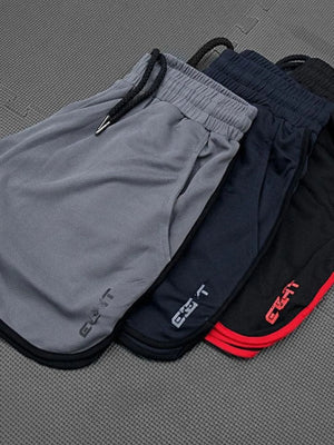 Performance shorts with contrast piping in black, royal blue, and dark gray.