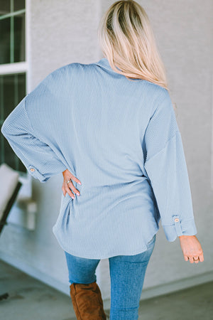 Light blue textured stripe oversized overshirt with button cuff details.