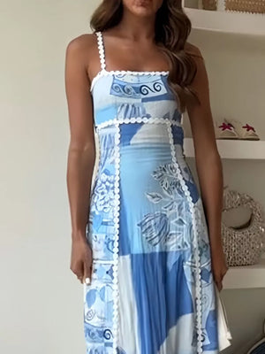 Blue patchwork maxi dress with abstract print and scalloped trim.