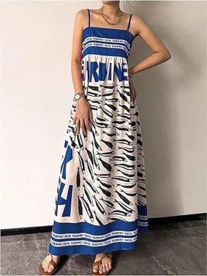 Blue spaghetti strap maxi dress with all-over sardine print and bold text detail.