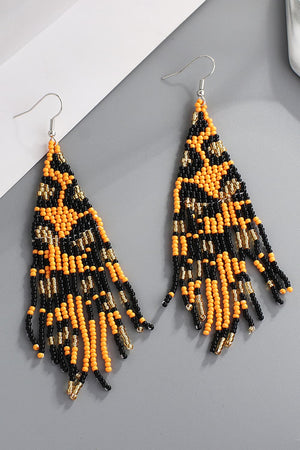 Leopard bead fringe earrings in tangerine and black with gold accents.