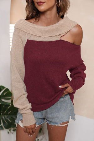 Asymmetric shoulder sweater in deep red and beige acrylic with a boat neck.