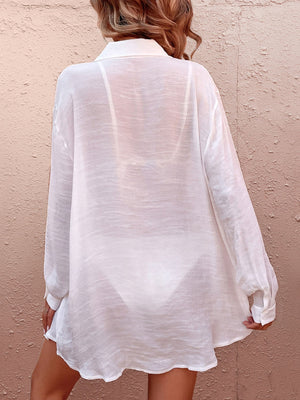White oversized linen beach shirt with tie detail, sheer fabric, long sleeves, buttoned cuffs.