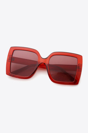 Crimson acetate rectangular sunglasses with dark lenses and bold frames.