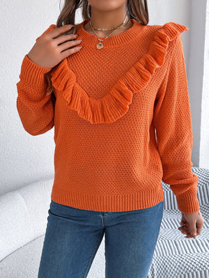 Orange knit sweater with textured yoke and ruffled detail, crew neck, long sleeves.