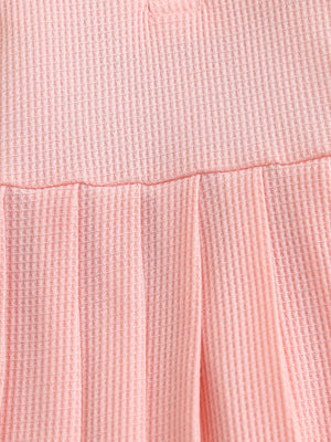 Pink waffle knit baby dress with gathered skirt detail