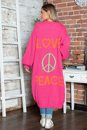 Pink knit maxi cardigan with orange LOVE and peace sign graphic, long sleeves