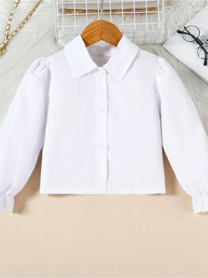 Toddler white collared long sleeve shirt with puff sleeves and ruffled cuffs.