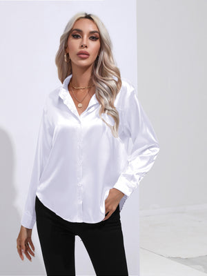White satin button-front blouse with collared neckline and long sleeves.