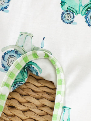 Baby one-piece with tractor print and green gingham trim, featuring snap closures.