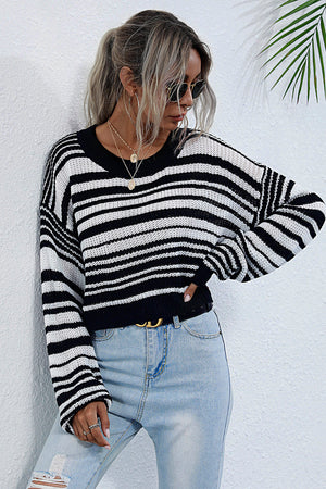 Cropped black and white stripe knit crew neck sweater with long sleeves.