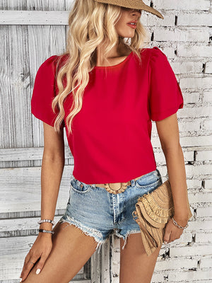 Red slit sleeve blouse with puff sleeves and a round neckline.