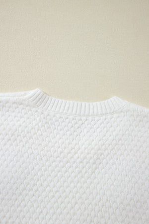 White knit sweater with textured diamond pattern and ribbed crew neck.