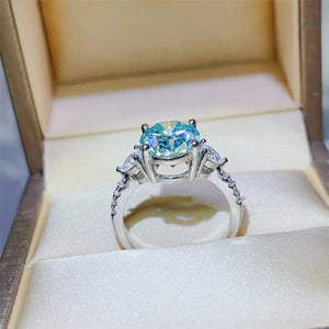 Turquoise moissanite trilogy ring in 925 sterling silver with pavé band