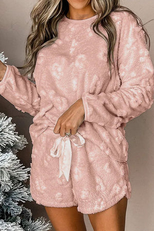 Textured blush pink loungewear set with shorts and a long sleeve top, featuring a tie waist.
