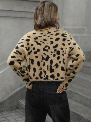 Fuzzy knit cropped sweater with leopard print, long sleeves, and crew neck.