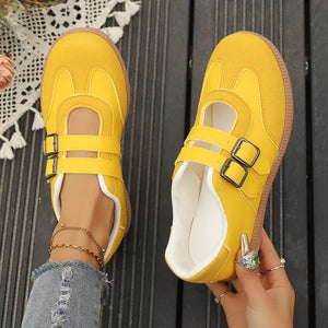 Yellow buckle strap Mary Jane inspired sneakers with double buckle closure and white trim.