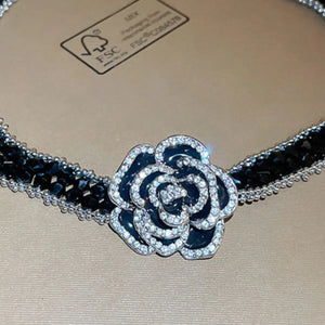 Black crystal rose choker necklace with silver trim and black enamel rose with crystal accents.