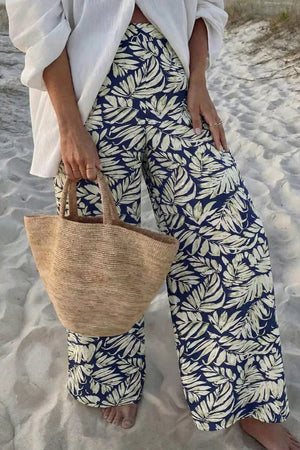 Navy leaf print maternity trousers with a high waist and wide leg, made of cotton.