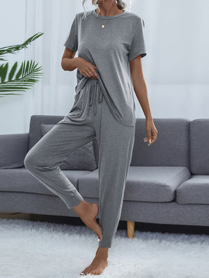 Relaxed-fit grey tee and jogger set with drawstring waist and cuffed ankles.