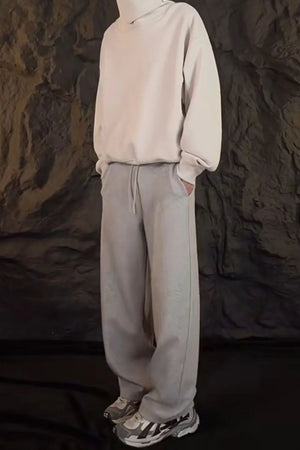 Relaxed-fit lounge trousers in dark gray with a drawstring waist and side pockets.