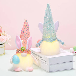 Easter bunny gnome with sequin cone hat and bunny ears, holding an egg.