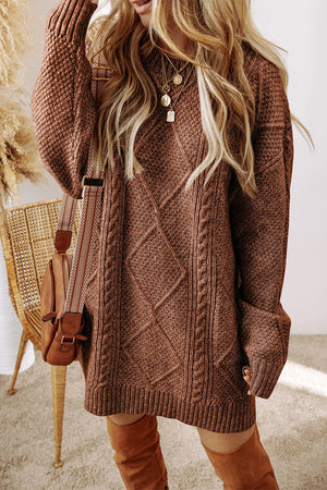 Tan cable knit sweater dress with diamond pattern and braided details.
