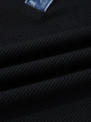Black textured knit polo top with denim trim detail