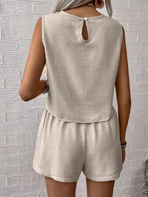 Textured beige two-piece set with V-notch top and elastic waist shorts.