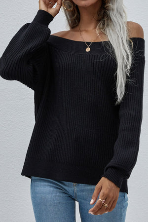 Black ribbed knit sweater with boatneck and puff sleeves, styled off-shoulder.
