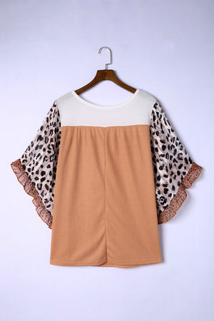 Colorblock waffle knit top with leopard print flutter sleeves and ruffled trim.