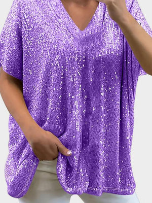Purple sequin slouchy V-neck top with short sleeves and pockets.