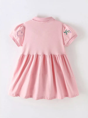 Pink cotton blend baby dress with embroidered heart and flower details on sleeves.