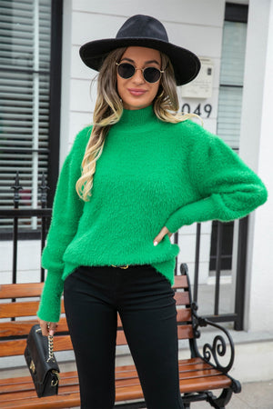 Fluffy green mock neck sweater with balloon sleeves.