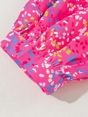 Hot pink blouse with a colorful abstract dot print and ruched mesh sleeves.