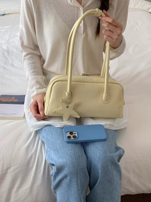 Chic Star Charm Mini Shoulder Bag in yellow with a star charm and double handles.