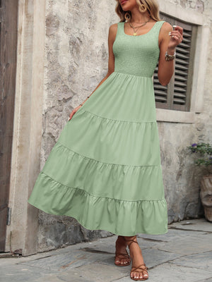 Light green smocked bodice tiered maxi dress with square neckline and sleeveless design.
