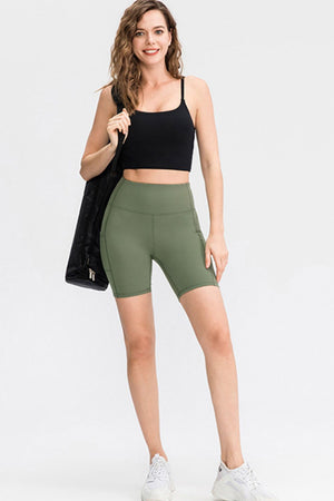 Army green sculpted pocket bike shorts with a high waist.