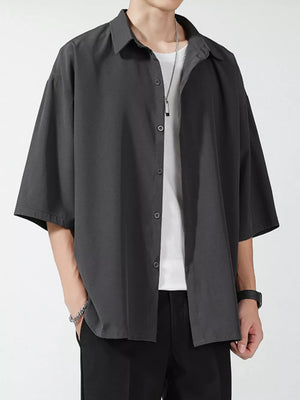 Men's oversized dark gray short sleeve button-up shirt with a relaxed fit.