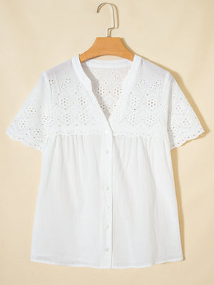 White cotton eyelet embroidered sheer shirt with short sleeves and button front.