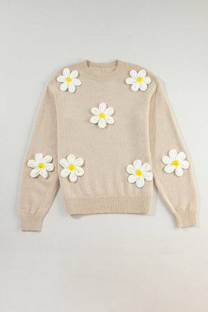 Tan knit sweater with embroidered white and yellow daisies, crew neck, long sleeves.