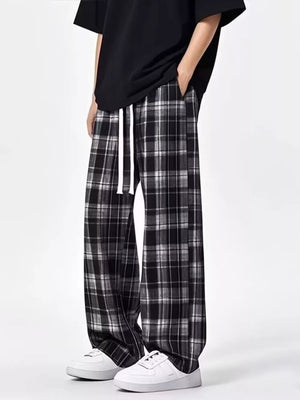 Plaid drawstring sweatpants in black with a relaxed fit.