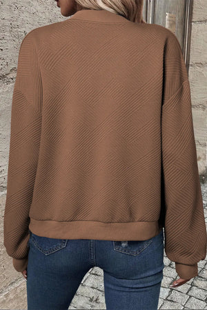Brown quilted bomber jacket with geometric texture and ribbed cuffs and hem