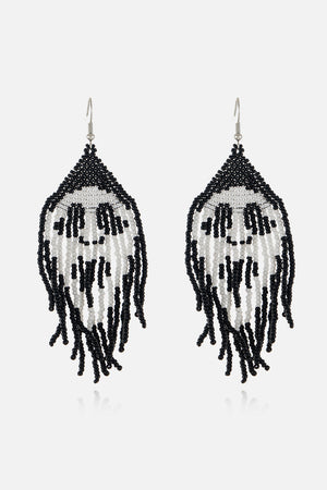 Beaded skull fringe earrings in black and white with dangling strands.