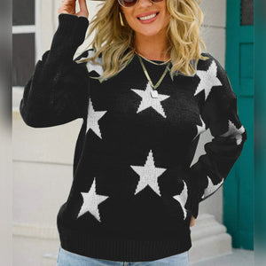 Black crewneck sweater with white stars, acrylic knit, long sleeves.